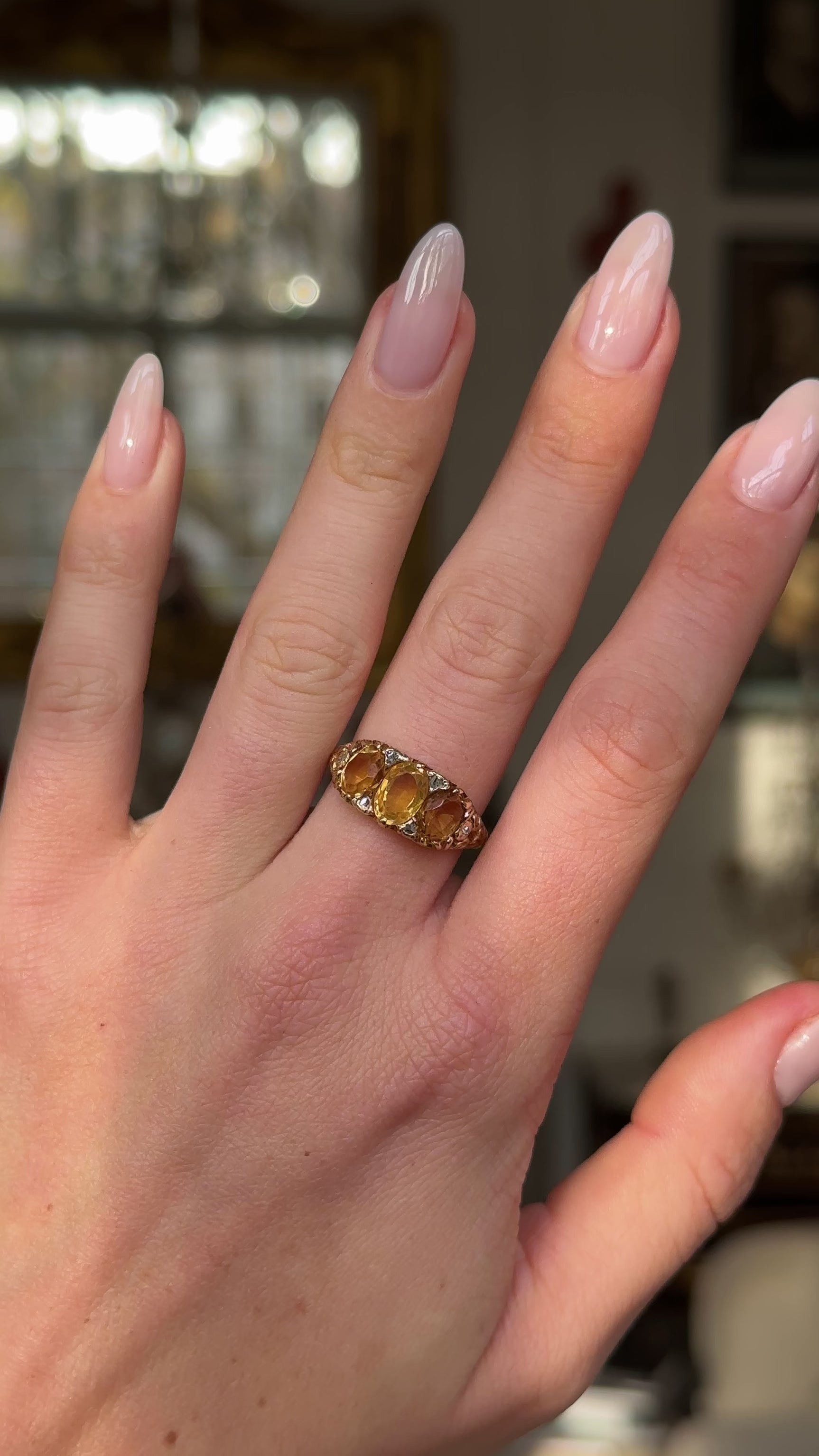 Three stone citrine ring worn on hand and moved around to give perspective.