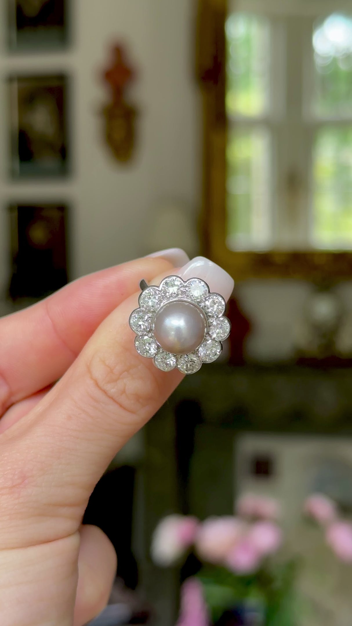Antique natural pearl and diamond ring, worn on hand and rotated to give perspective. Antique natural pearl and diamond ring, held in fingers and rotated to give perspective. 