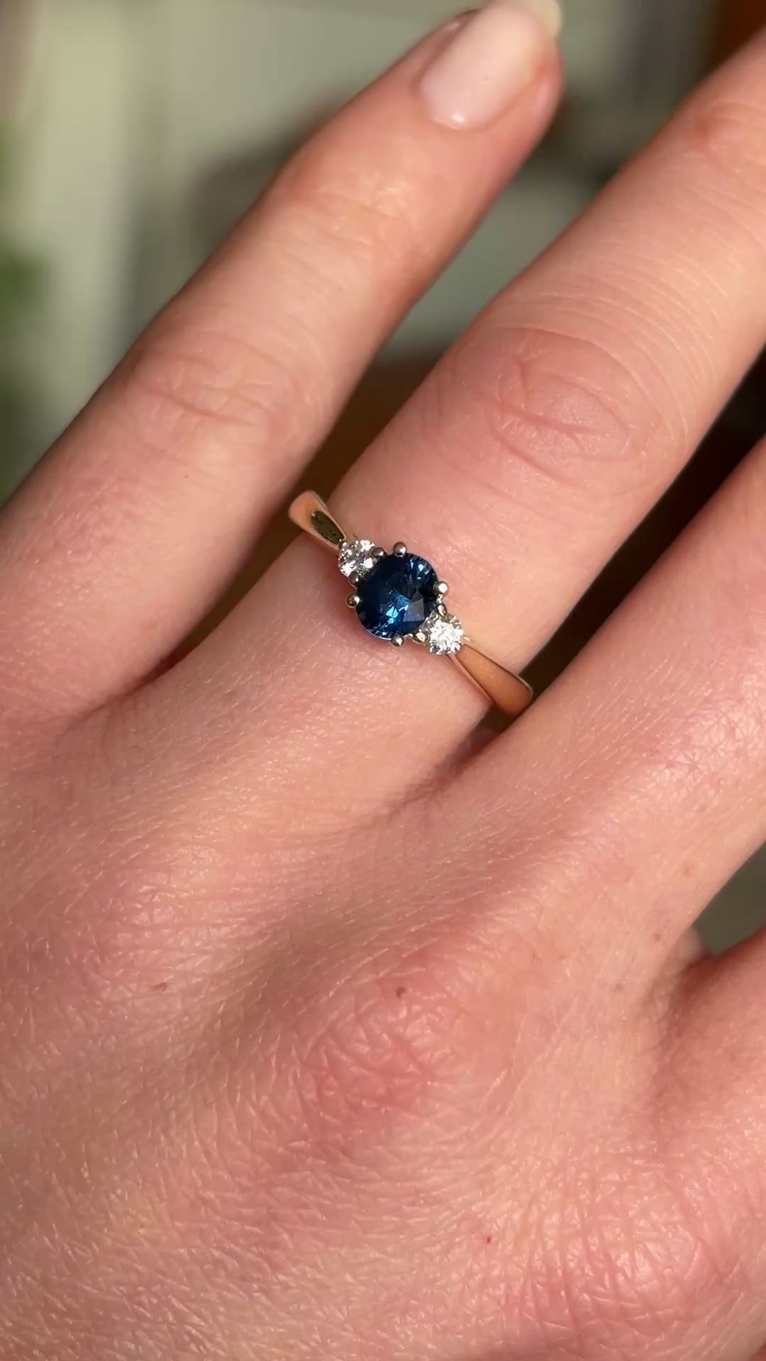 Blue sapphire and diamond three-stone engagement ring
