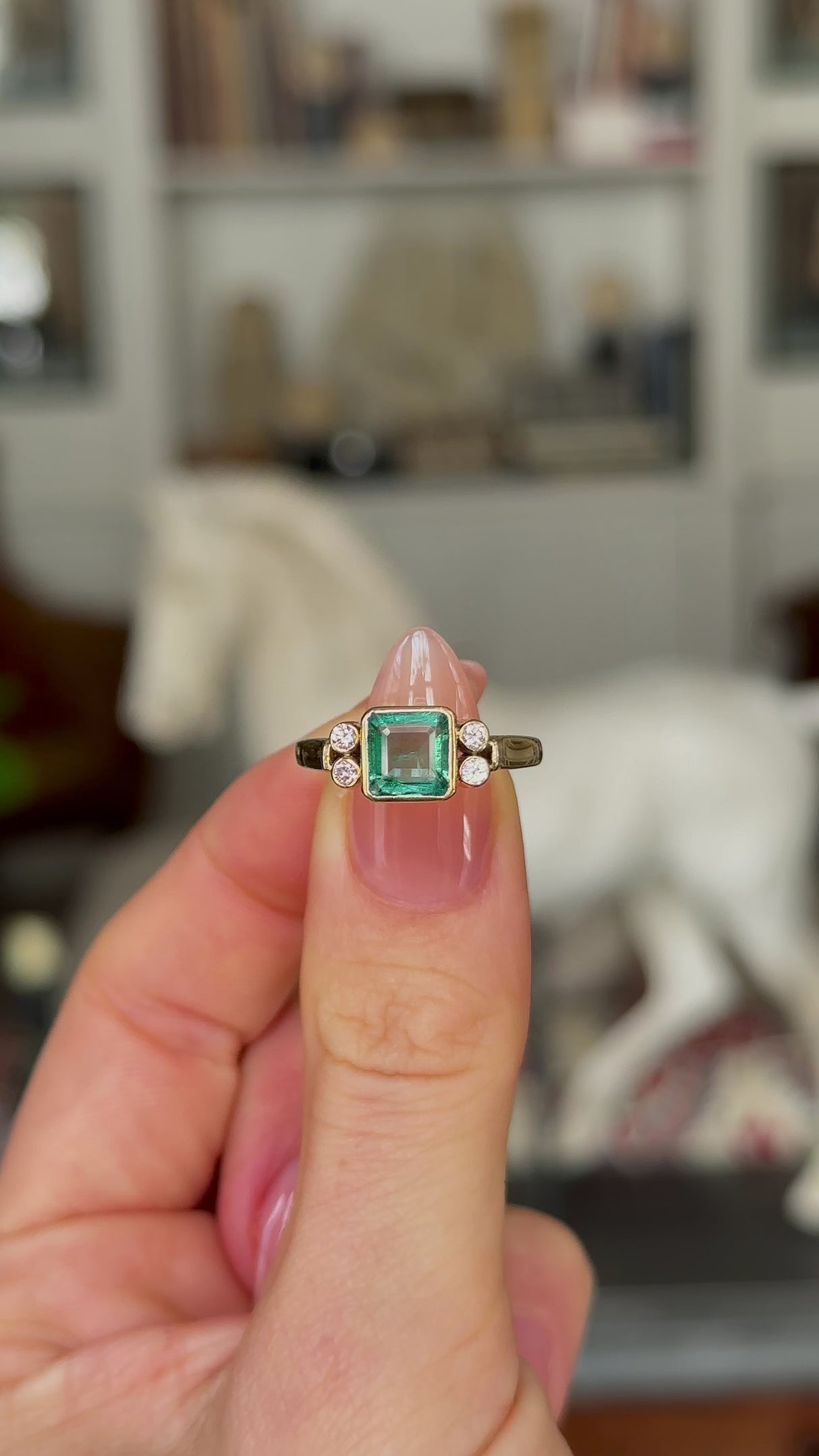 Vintage, Emerald and Diamond Ring, 18ct Yellow Gold held in fingers and rotated to give perspective.