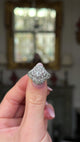 edwardian diamond bombe ring held in fingers and moved around to give perspective.