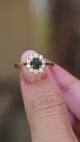 Antique-inspired, deep teal sapphire and diamond cluster engagement ring