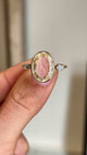 Closeup video of a Vintage, 1980s engagement ring with a large central yellow sapphire flanked by two diamonds on either side.  Rotated to showcase it from every profile. 
