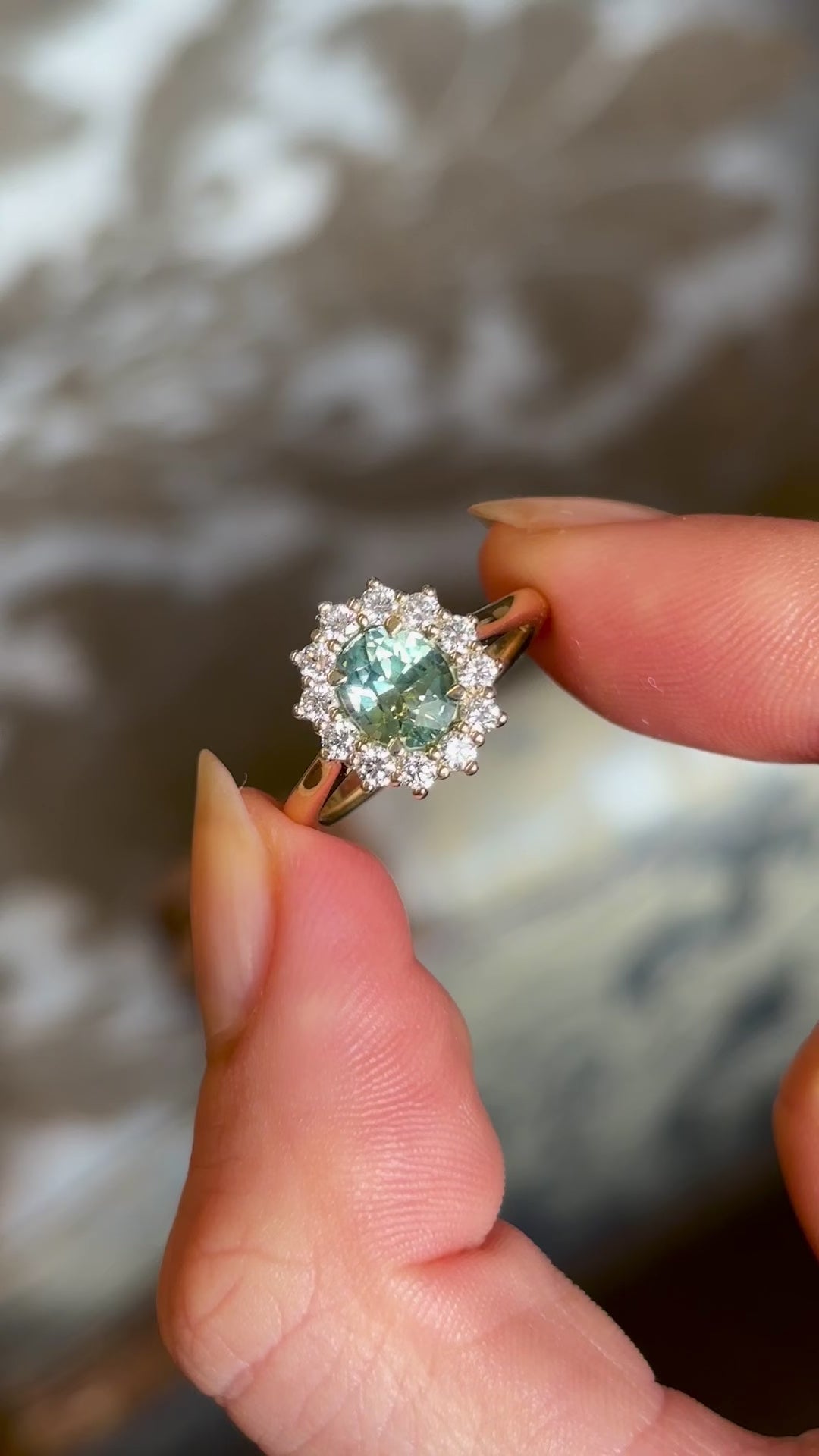 Green sapphire and diamond cluster engagement ring