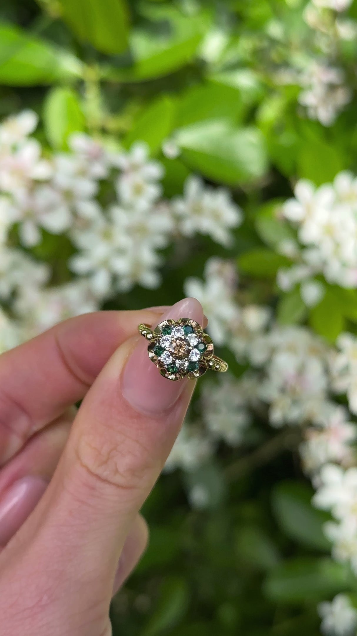 Vintage, 1970s Cognac Diamond, Emerald and White Spinel Ring, 9ct Yellow Gold held in fingers.