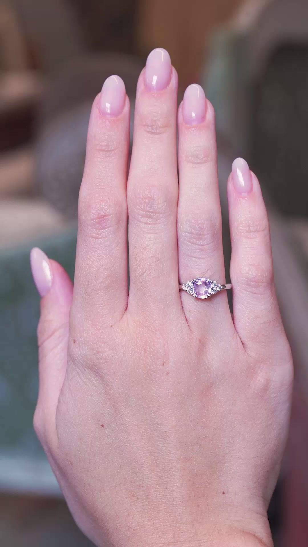 Pink sapphire and diamond cluster tre-foil engagement ring worn on hand with subtle movements.
