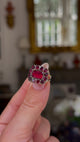 Georgian garnet cluster ring  held in fingers and moved around to give perspective.