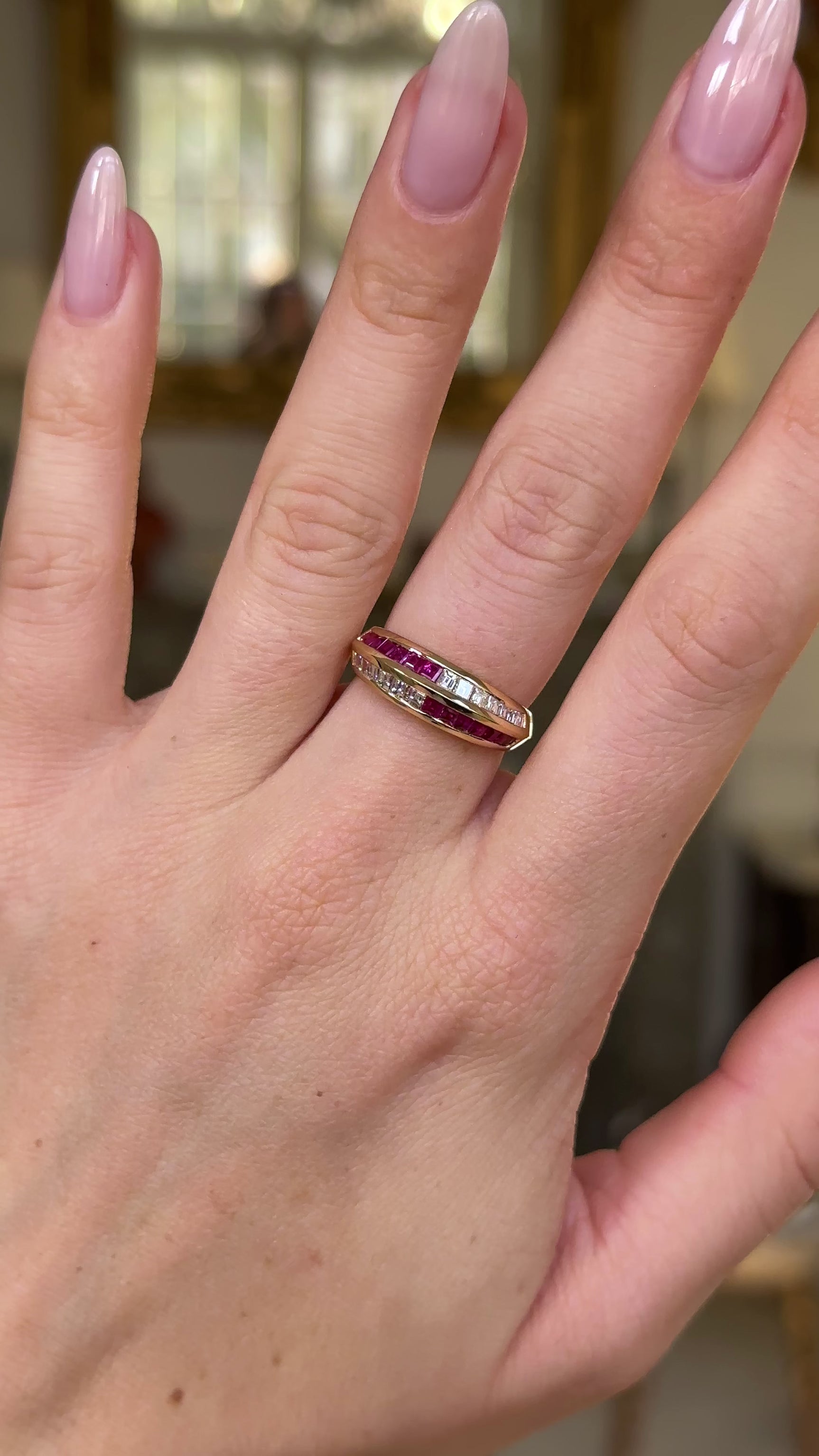Ruby and diamond half eternity ring worn on hand and moved around to give perspective.