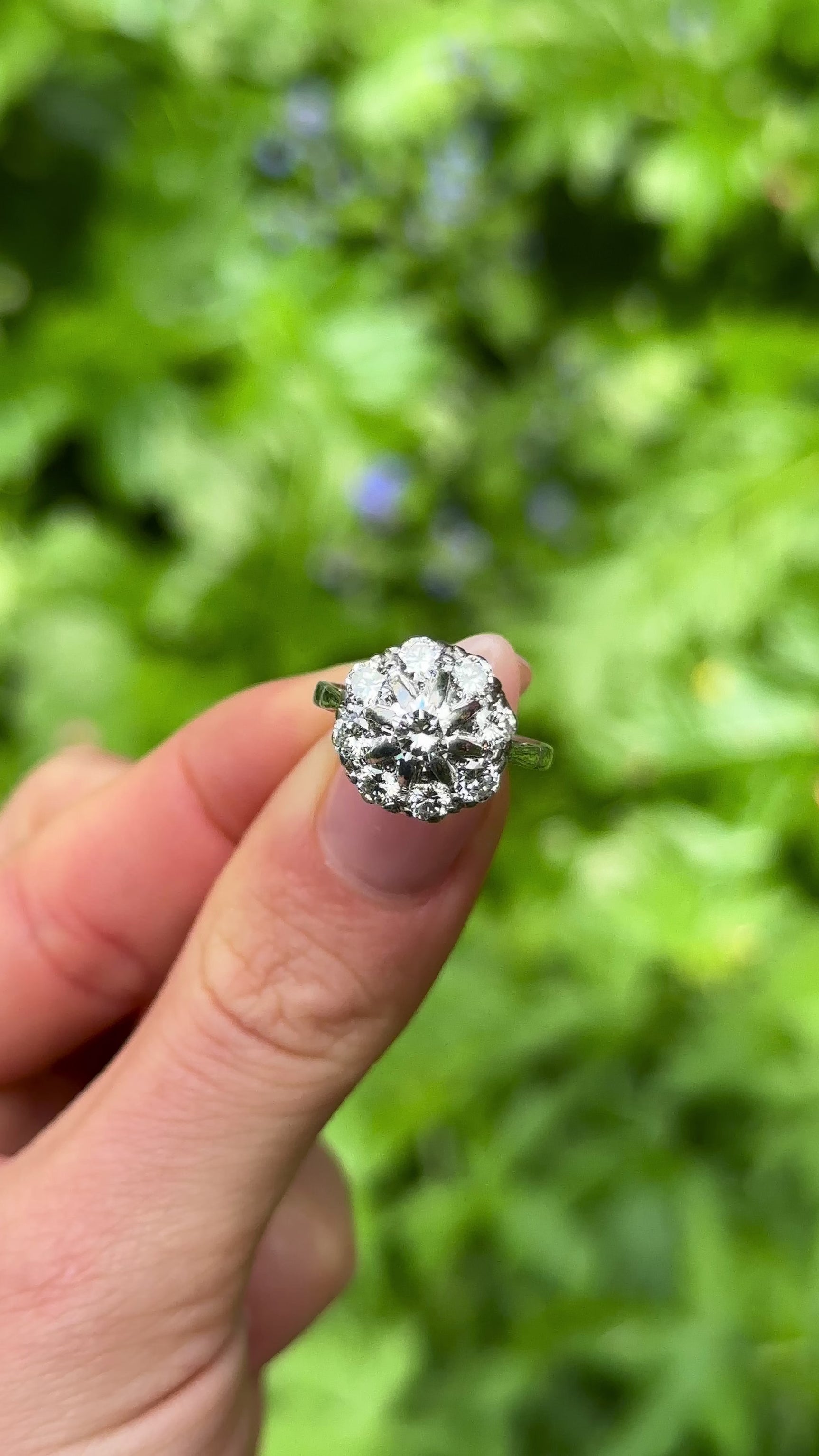 Vintage, Diamond Cluster Engagement Ring, 18ct White Gold held in fingers.