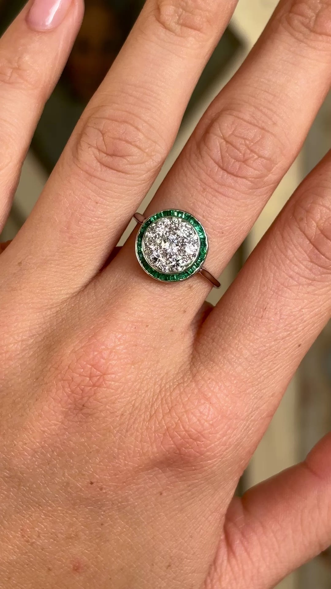 Vintage, Art Deco emerald & diamond target cluster ring worn on hand.