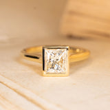 Princess-cut diamond solitaire engagement ring featuring a sparkling square-cut diamond in polished yellow gold.