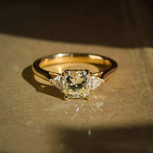 Round 1.07ct diamond with side diamonds three stone engagement ring in yellow gold