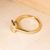 Princess-cut diamond solitaire ring showcasing a bright square diamond in an elegant yellow gold design.