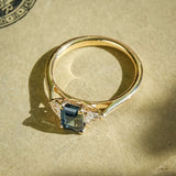 Teal sapphire and diamond three stone engagement ring in classic yellow gold setting