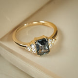 Teal sapphire and diamond trefoil cluster engagement ring in yellow gold