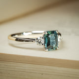 Teal sapphire three stone diamond ring with platinum setting