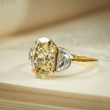Three stone engagement ring with yellow oval diamond and half moon diamonds