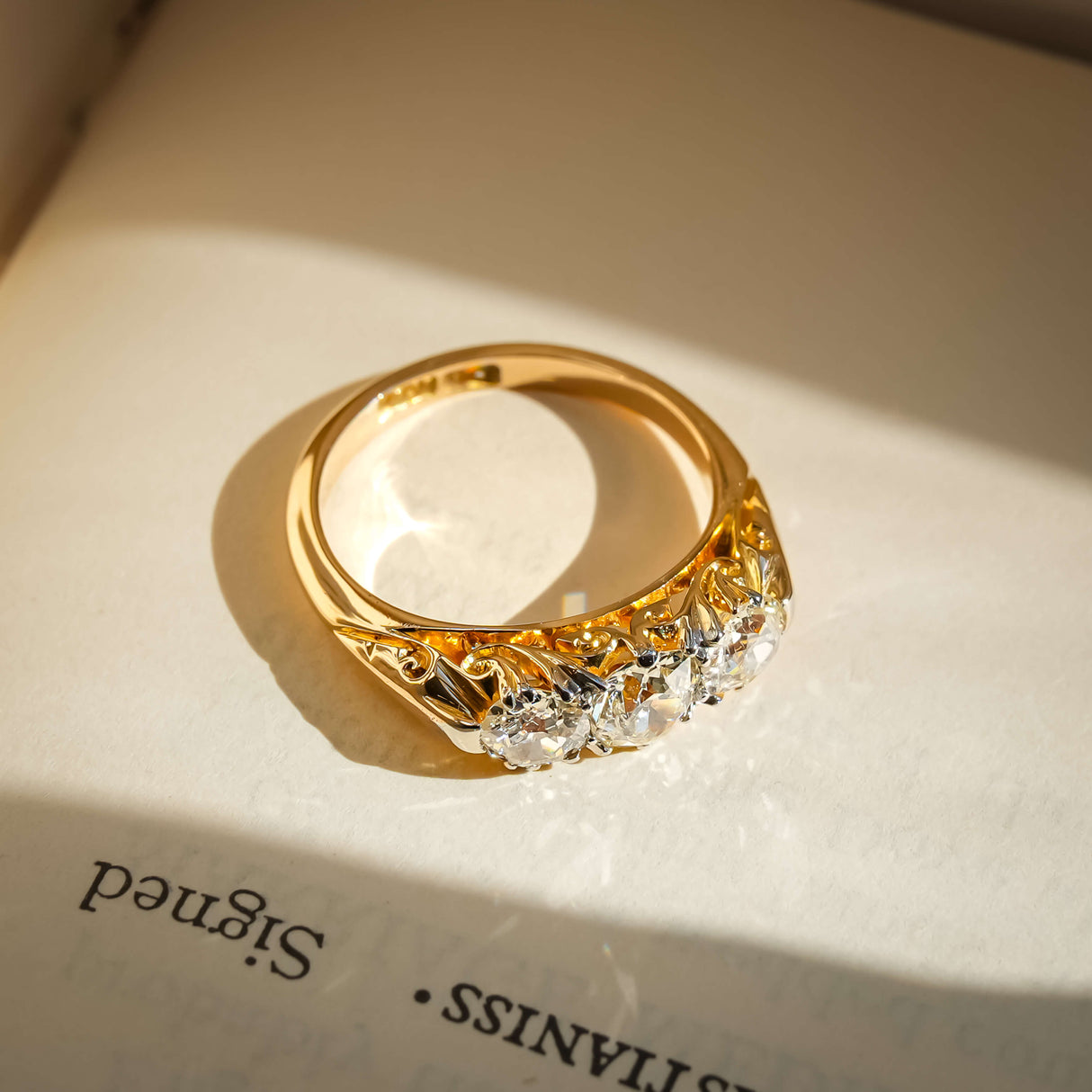 victorian diamond three stone ring with antique design in yellow gold