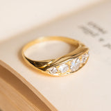 Antique Victorian five-stone ring featuring graduated old-mine cut diamonds in carved yellow gold setting.