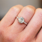 Vintage 1930s diamond engagement ring shown on a finger.