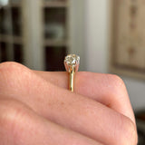 Vintage 1950s brown old-mine cut diamond solitaire engagement ring featuring a brown old-mine cut diamond in a classic solitaire setting, worn on a hand.
