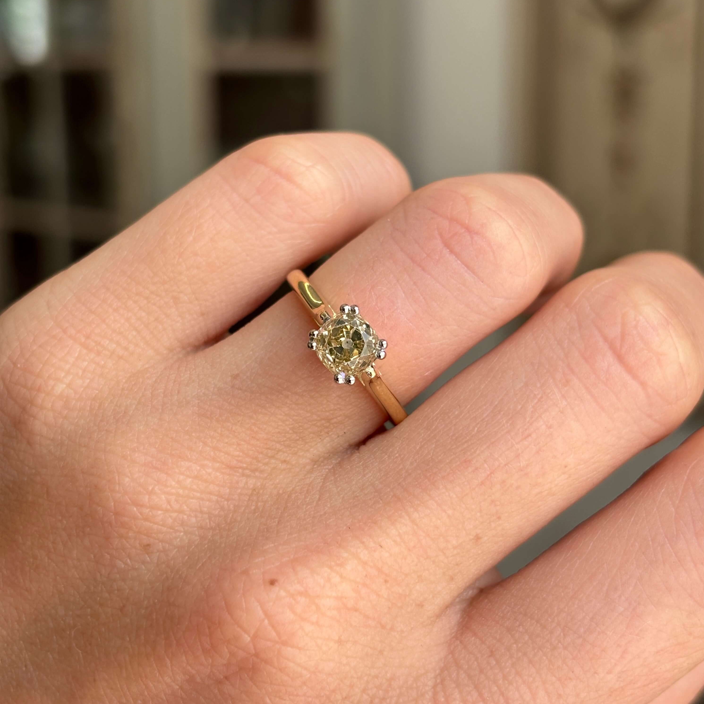 Vintage 1950s brown old-mine cut diamond solitaire engagement ring with a brown old-mine cut diamond centre stone, worn on a hand.