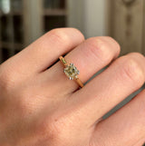 Vintage 1950s brown old-mine cut diamond solitaire engagement ring with a brown old-mine cut diamond centre stone, worn on a hand.