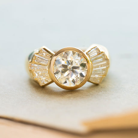 Vintage 1950s old-cut diamond fan engagement ring with bezel-set centre and diamond accents.