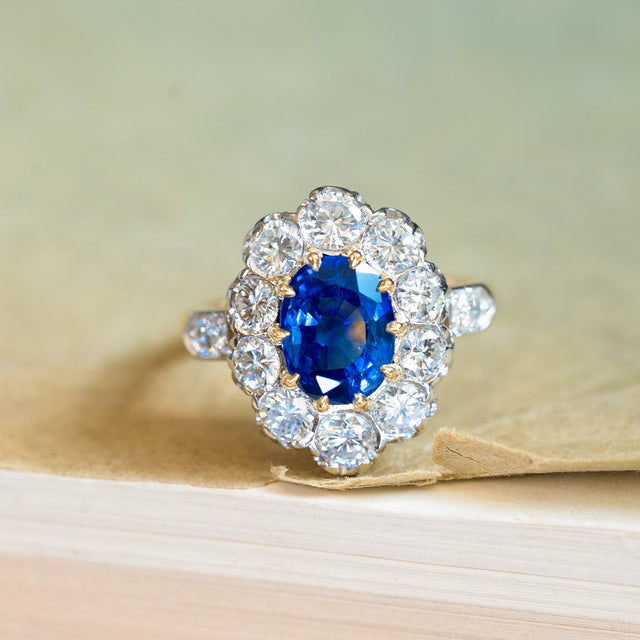 Vintage 1960s French sapphire and diamond cluster ring with vivid blue sapphire and brilliant diamond halo.