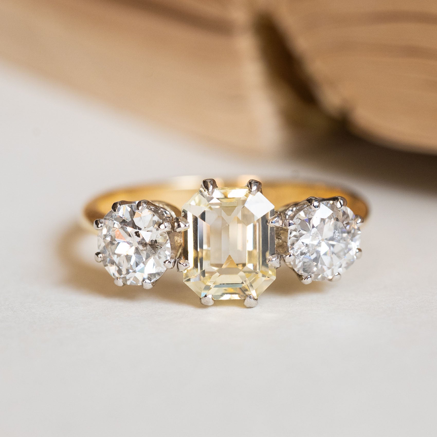 Vintage 1970s yellow sapphire and old-cut diamond three-stone ring featuring a yellow sapphire centre stone.