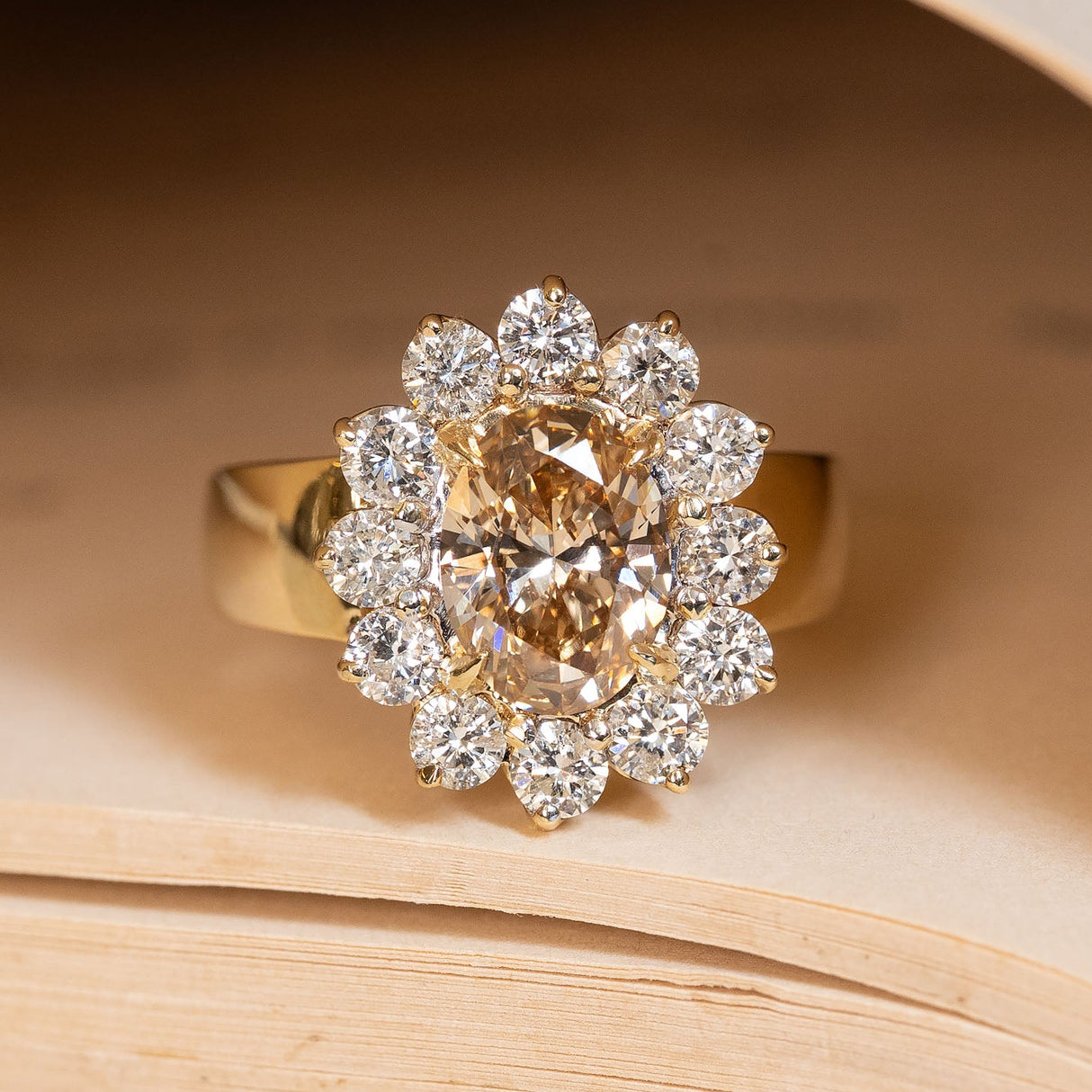 Vintage 1980s fancy coloured brown diamond cluster cocktail ring featuring an oval brown diamond surrounded by a sparkling cluster of brilliant-cut white diamonds in yellow gold.