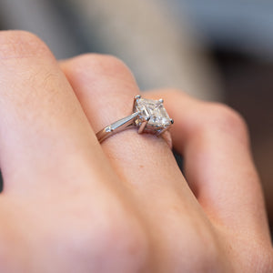 Vintage 1980s solitaire diamond ring showing details and elevated setting .