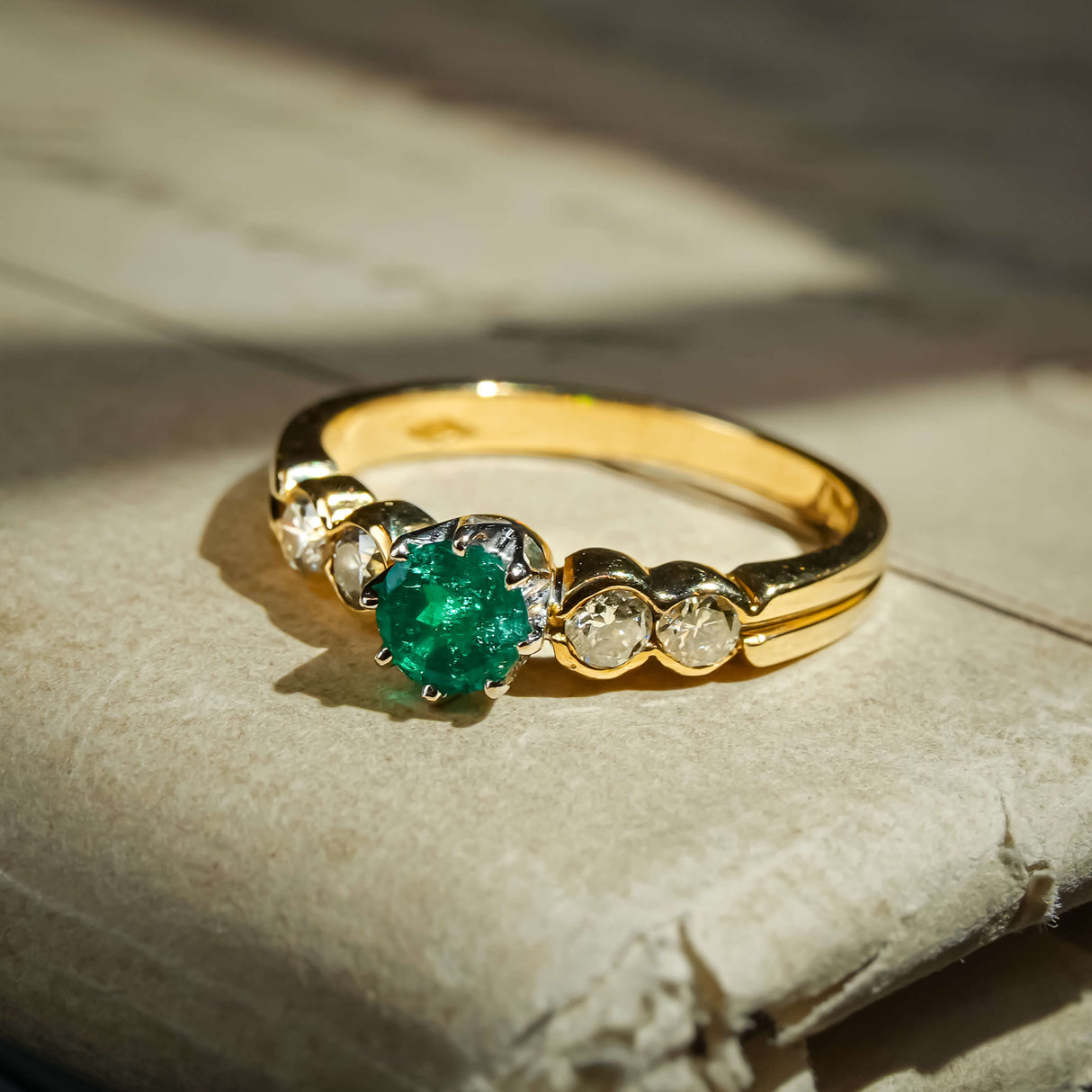 Vintage 1990s emerald and diamond five stone ring with round green emerald and diamond accents