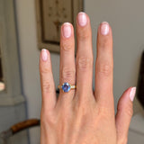 Vintage 1990s sapphire and diamond engagement ring featuring a blue sapphire centre stone and diamond accents, displayed on a hand.