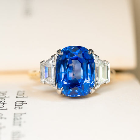 Vintage 1990s sapphire and diamond three-stone ring with vibrant blue sapphire centre and tapered diamond side stones.