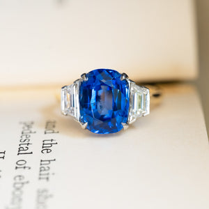 Vintage 1990s sapphire and diamond three-stone ring with vivid blue cushion-cut sapphire.