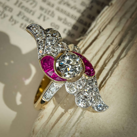 Vintage Art Nouveau diamond and ruby cocktail ring with curved design and diamond details
