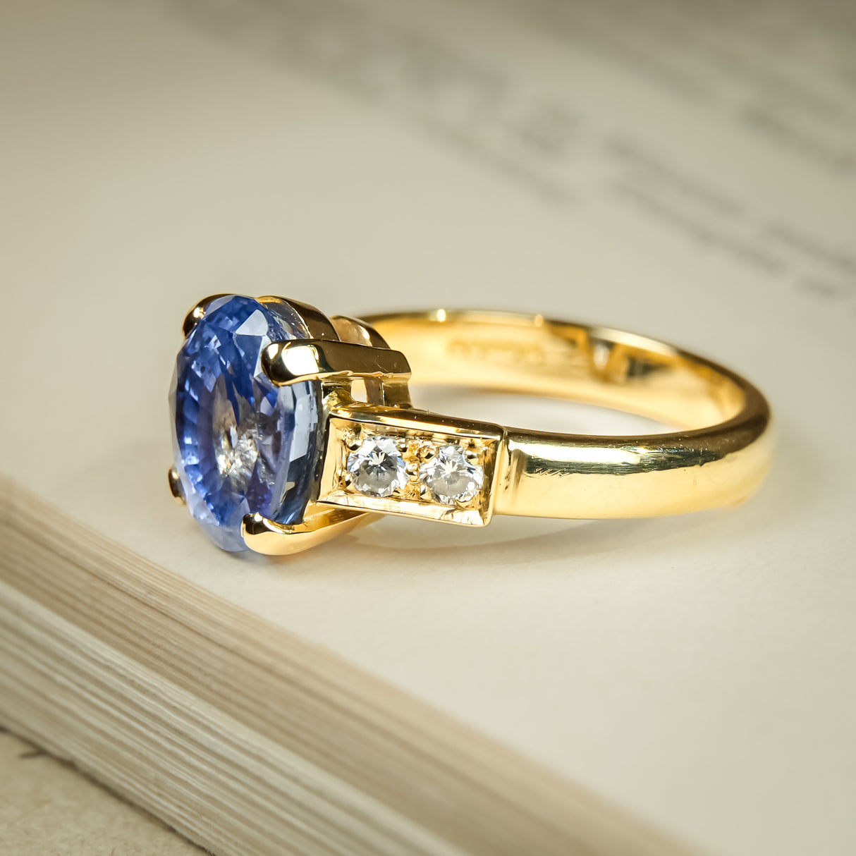 Vintage blue sapphire engagement ring with diamond set yellow gold band