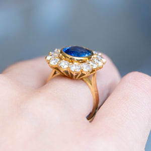 Vintage 1960s French sapphire and diamond cluster ring with elevated gold gallery and oval sapphire centre.
