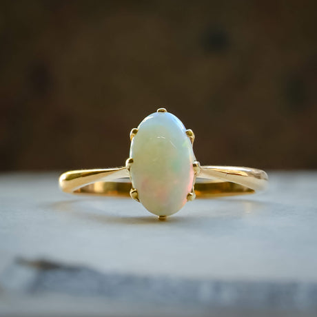 vintage precious opal solitaire ring from the 1990s in yellow gold