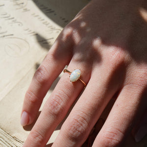 Vintage precious opal solitaire ring with oval gemstone in yellow gold