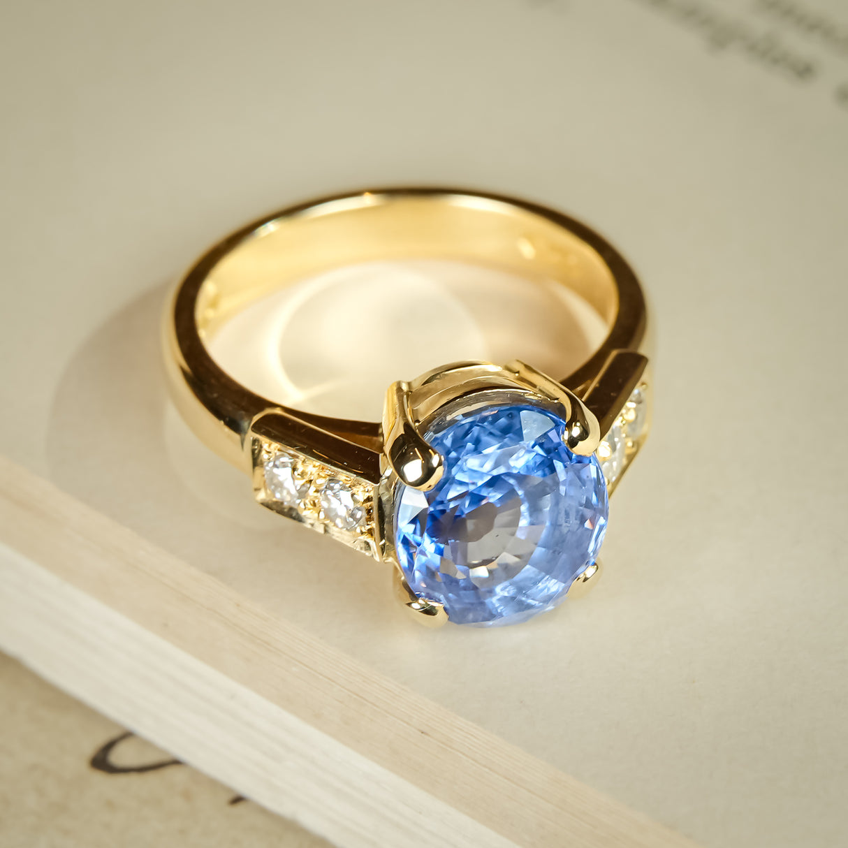 Vintage oval blue sapphire and diamond ring in yellow gold