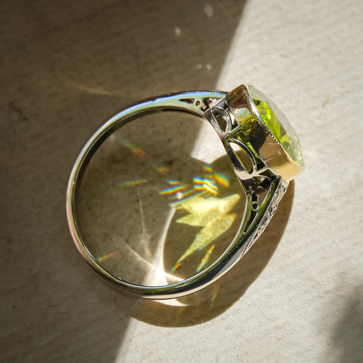 Vintage Art Deco peridot ring with oval green gemstone in diamond setting