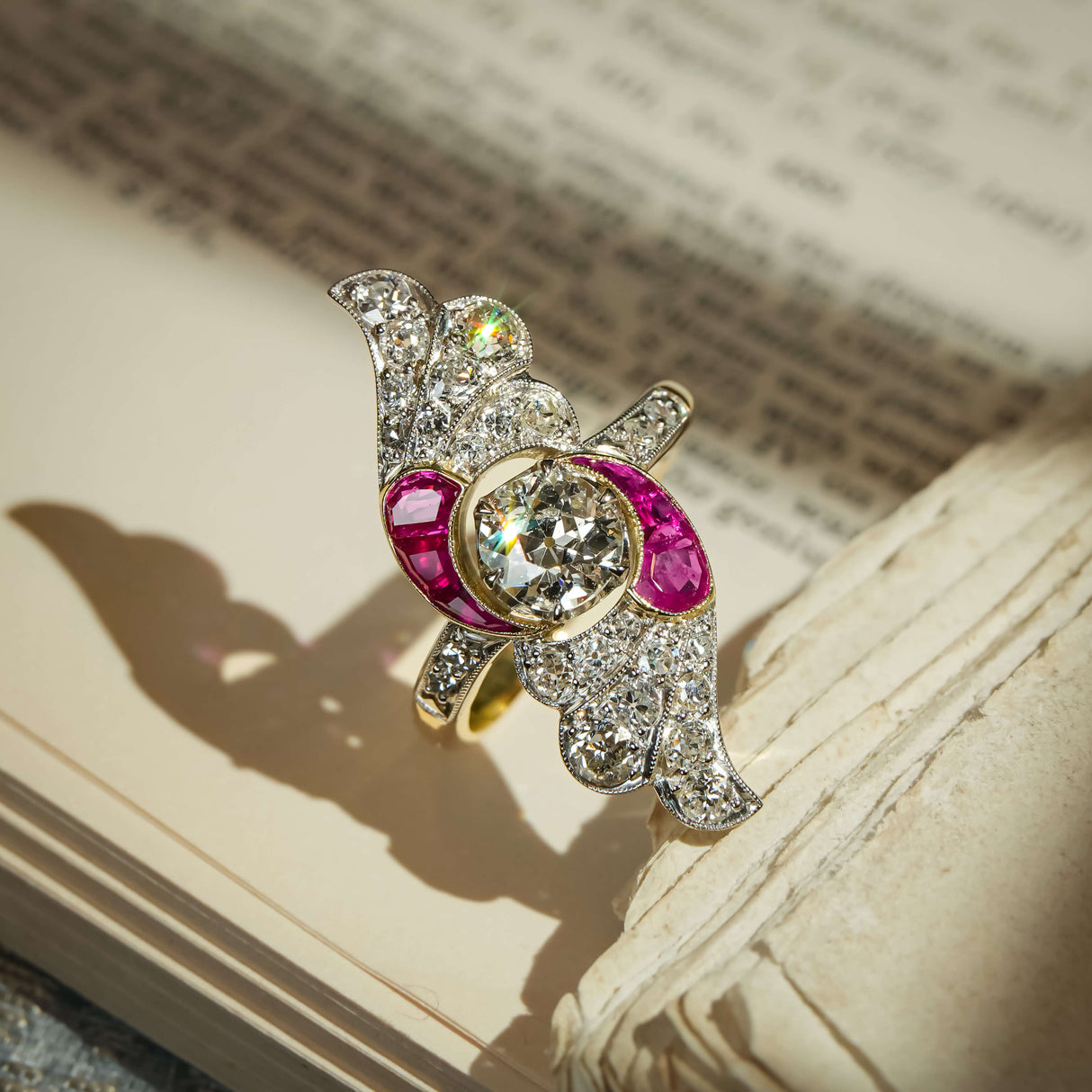 Vintage Art Nouveau ruby and diamond cocktail ring with central diamond and curved ruby accents