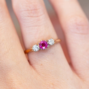 Vintage ruby and diamond three-stone ring with vivid pink ruby centre stone.