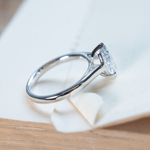 Vintage 1990s salt and pepper diamond solitaire ring with tapered polished band and pear-shaped diamond.