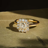 vintage style cushion diamond cluster engagement ring with brilliant halo