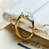 Vintage yellow oval diamond and half-moon diamond ring with elevated claw-set gallery.