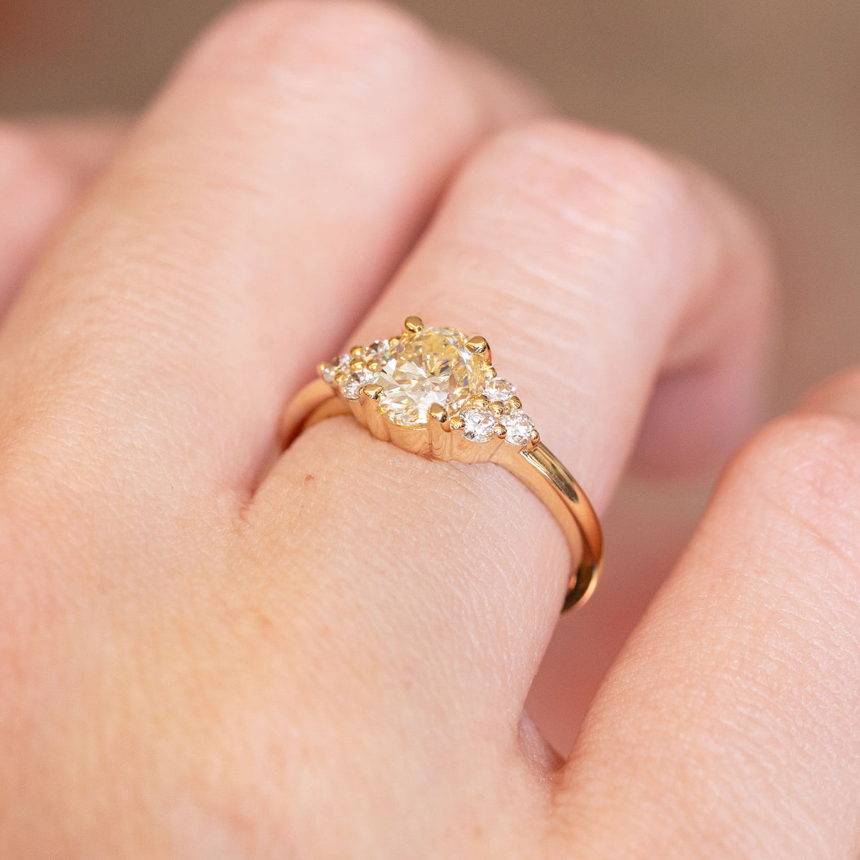 Antique-inspired primrose yellow diamond cluster tre-foil engagement ring with diamond cluster detailing and gold band.