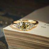 Fancy light yellow diamond ring with trefoil cluster and white diamond side stones in gold